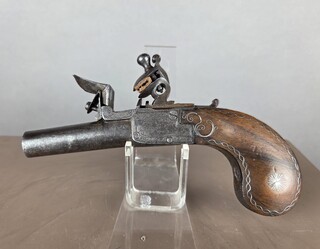 Small flintlock pistol with a box-shaped stock, silver threads in the grip, France, circa 1800