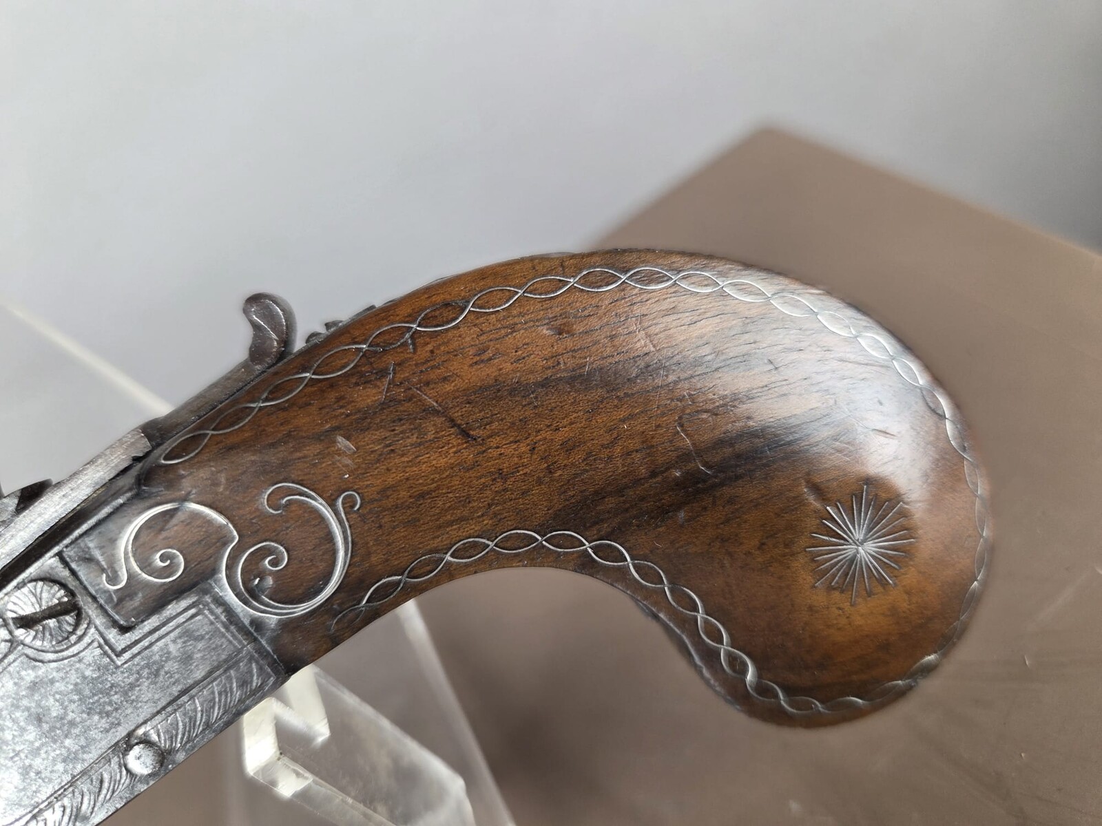 Small flintlock pistol with a box-shaped stock, silver threads in the grip, France, circa 1800