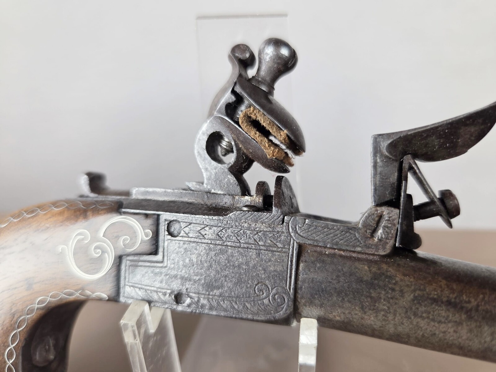 Small flintlock pistol with a box-shaped stock, silver threads in the grip, France, circa 1800