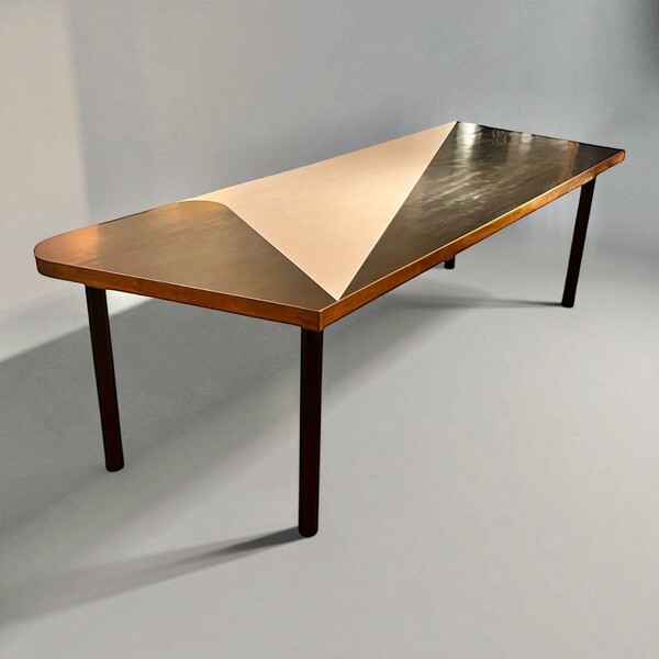Black and white laminate dining table with brass trim and black lacquered steel legs. Circa 1960