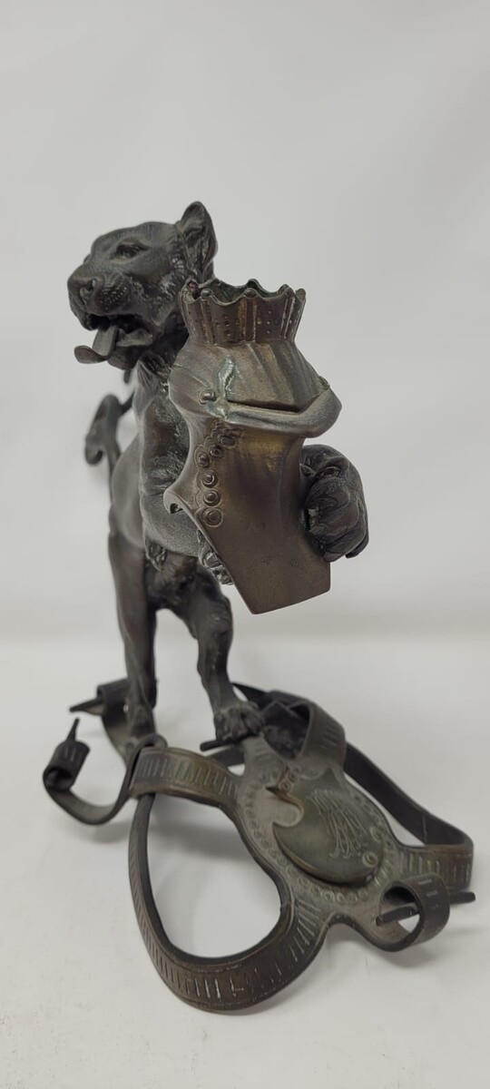 Bronze candlestick with black patina representing a young lion wearing a helm