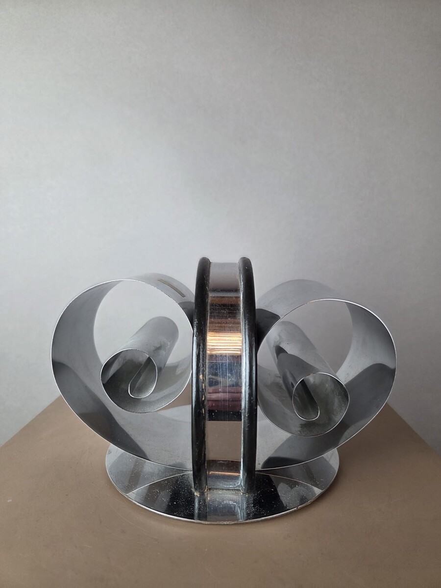 chrome-plated metal and lacquered wood bookend, circa 1935