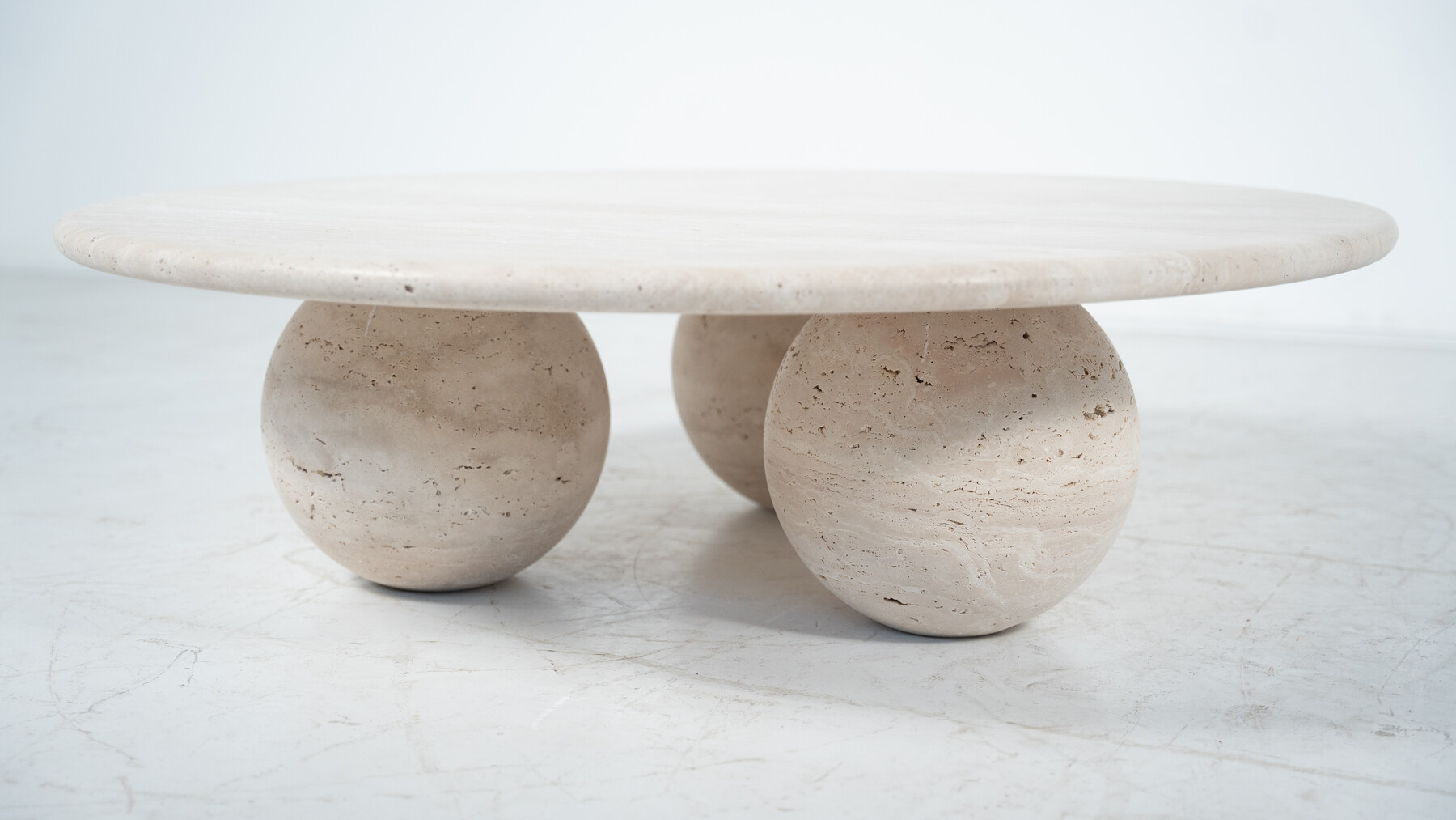 Contemporary round coffee table made of travertine, Italy