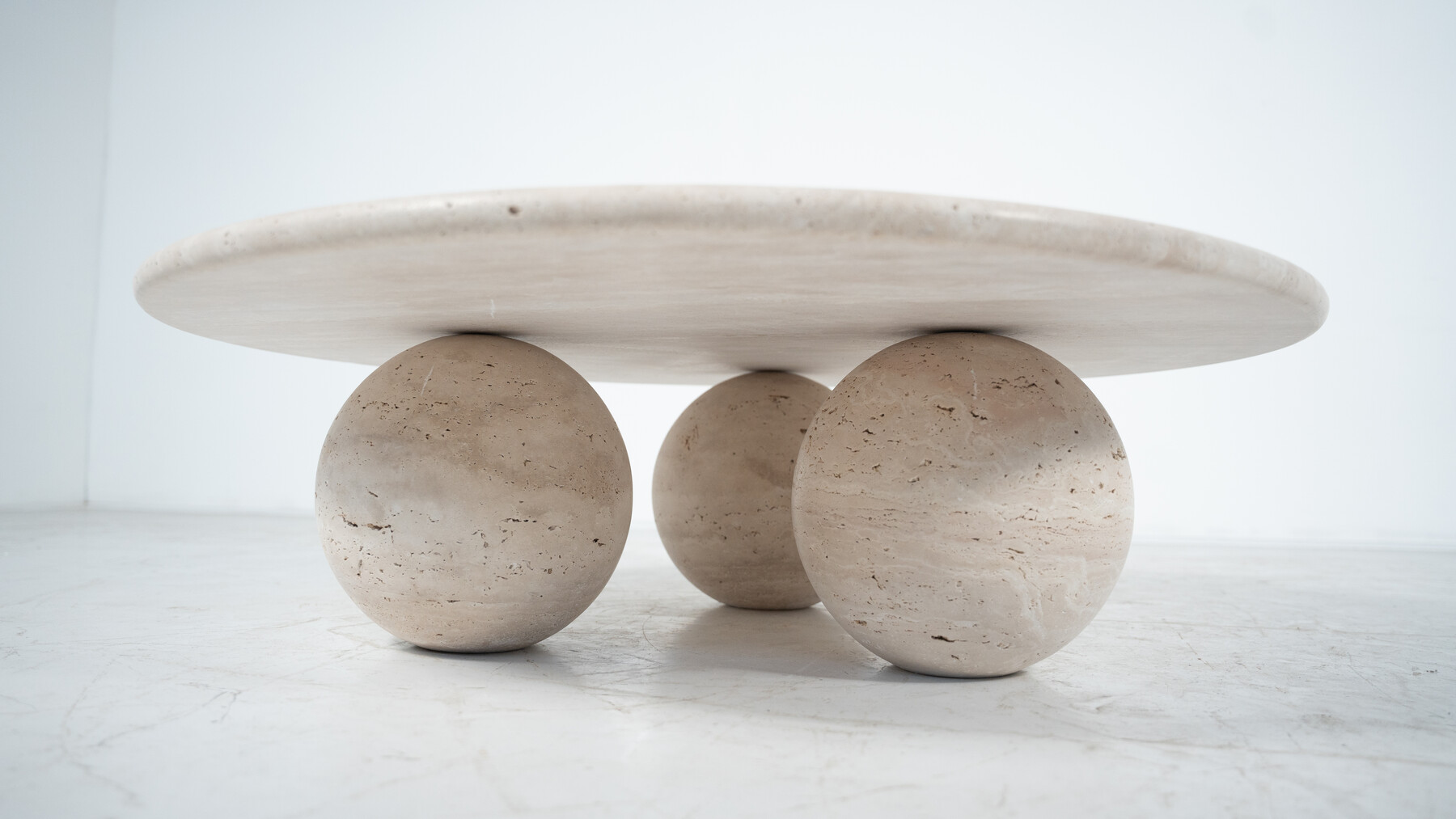 Contemporary round coffee table made of travertine, Italy