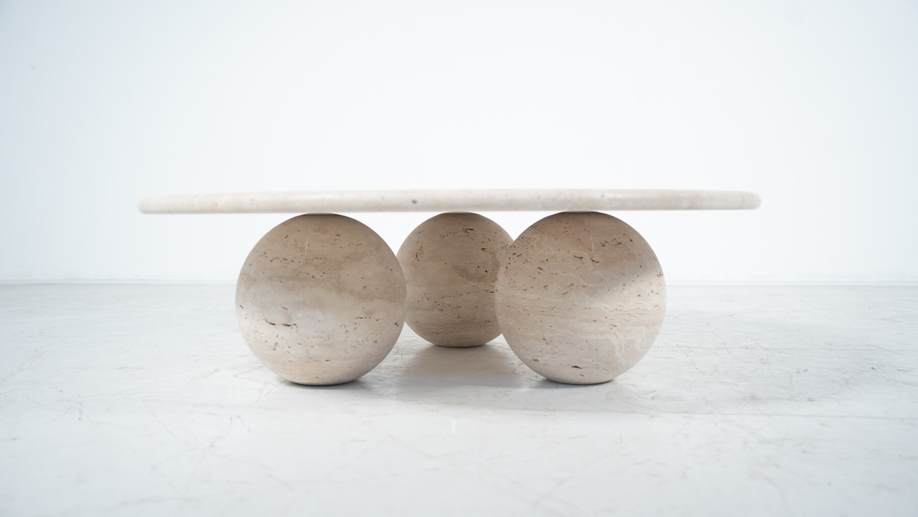 Contemporary round coffee table made of travertine, Italy