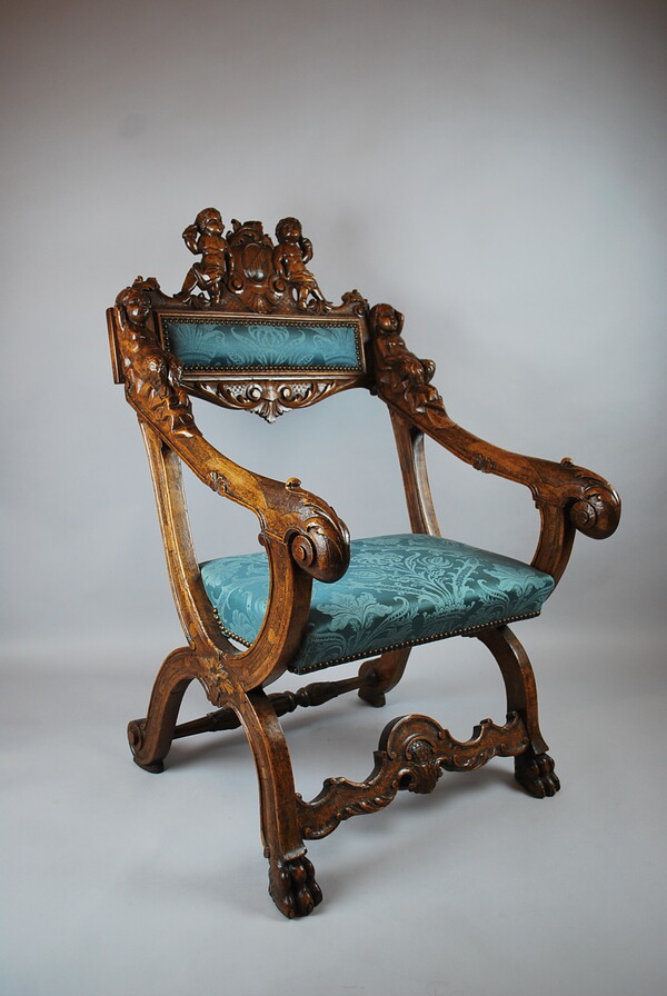 Curule armchair in carved wood, early 20th