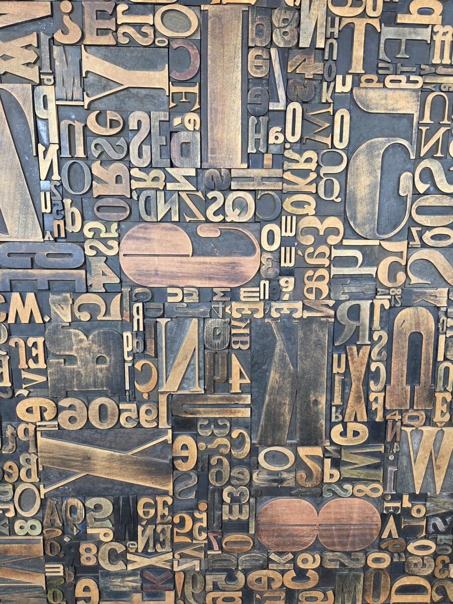 Decorative panel adorned with antique printing letters. 2 pieces available.