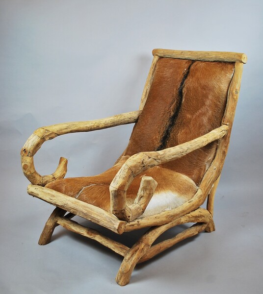 Folk art, large wooden armchair trimmed with a skin, 20th