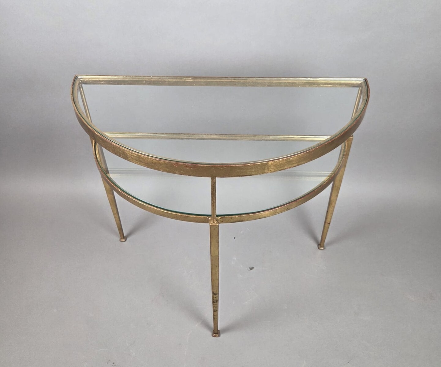 Half-moon console table in gilded wrought iron with glass shelves