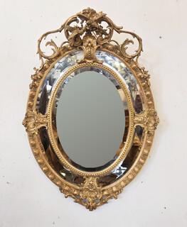 Louis XIV style medallion mirror in wood and gilded stucco, 19th