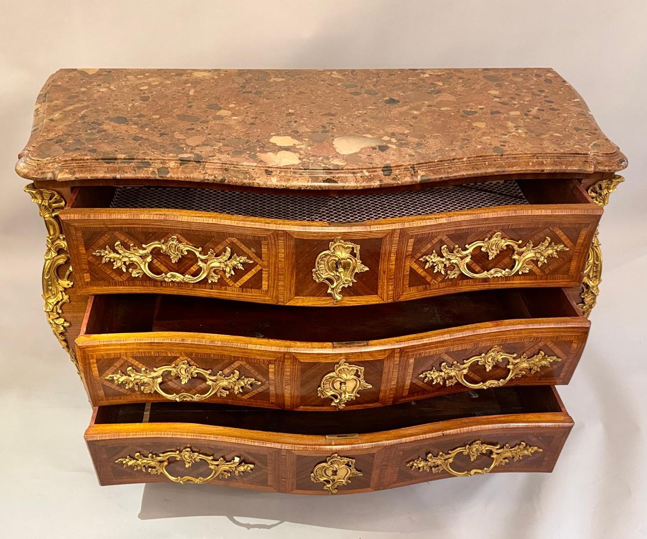 Louis XV style marquetry crossbow chest of drawers