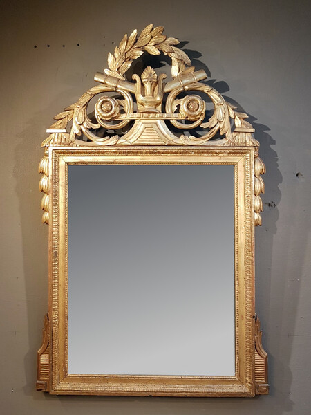 Louis XVI period mirror in gilded wood