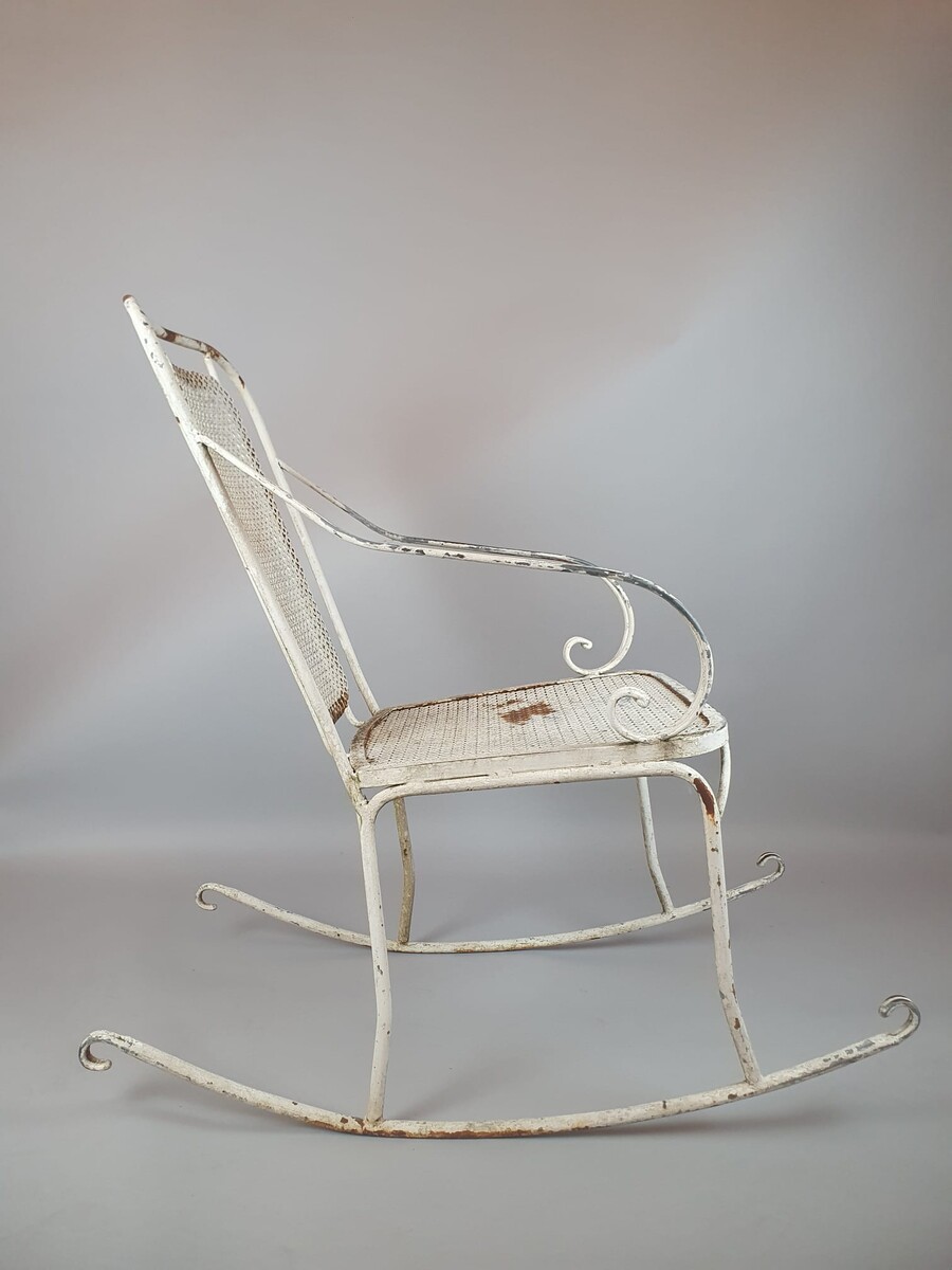 Pair of wrought iron and perforated metal rocking chairs, circa 1960