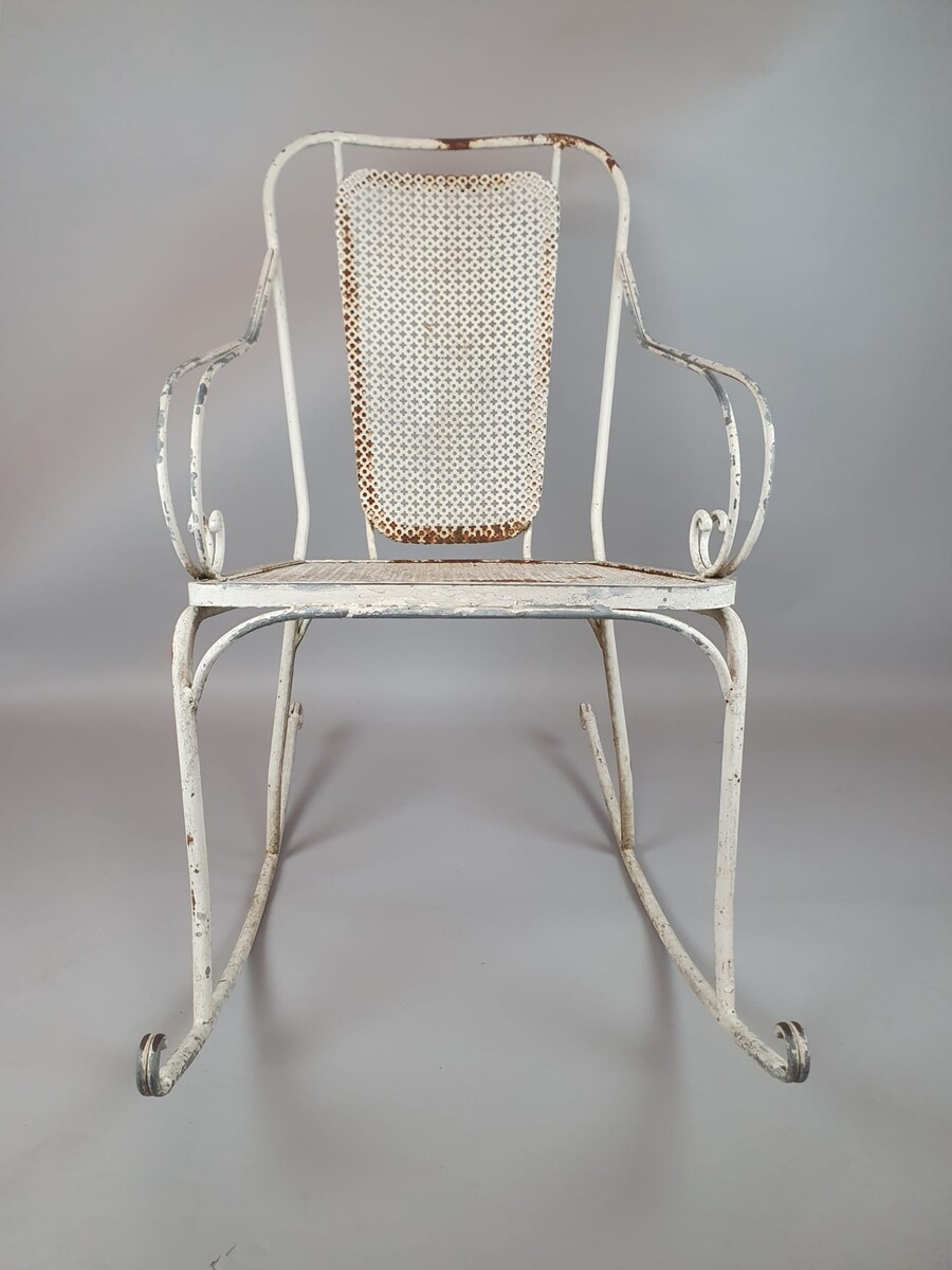 Pair of wrought iron and perforated metal rocking chairs, circa 1960