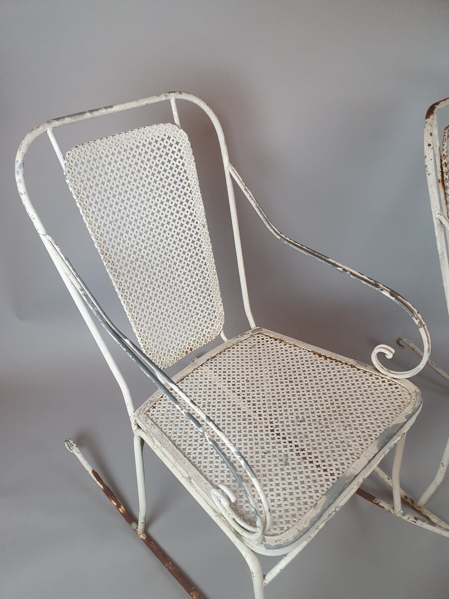 Pair of wrought iron and perforated metal rocking chairs, circa 1960