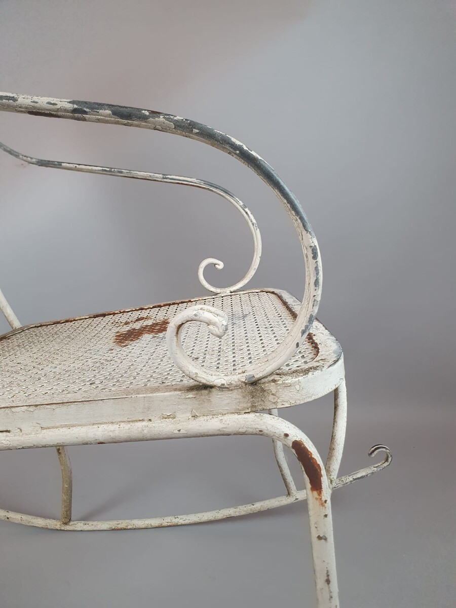Pair of wrought iron and perforated metal rocking chairs, circa 1960