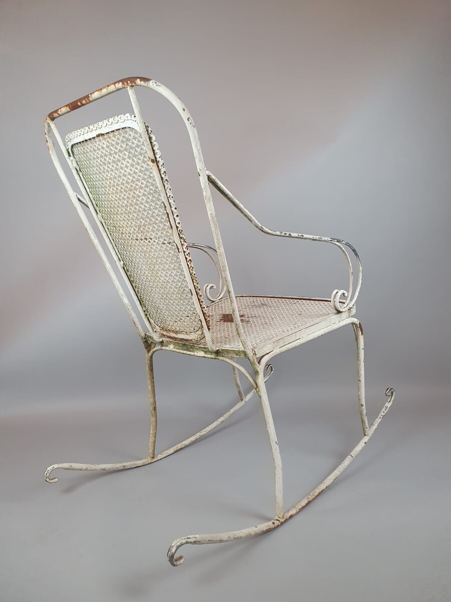 Pair of wrought iron and perforated metal rocking chairs, circa 1960