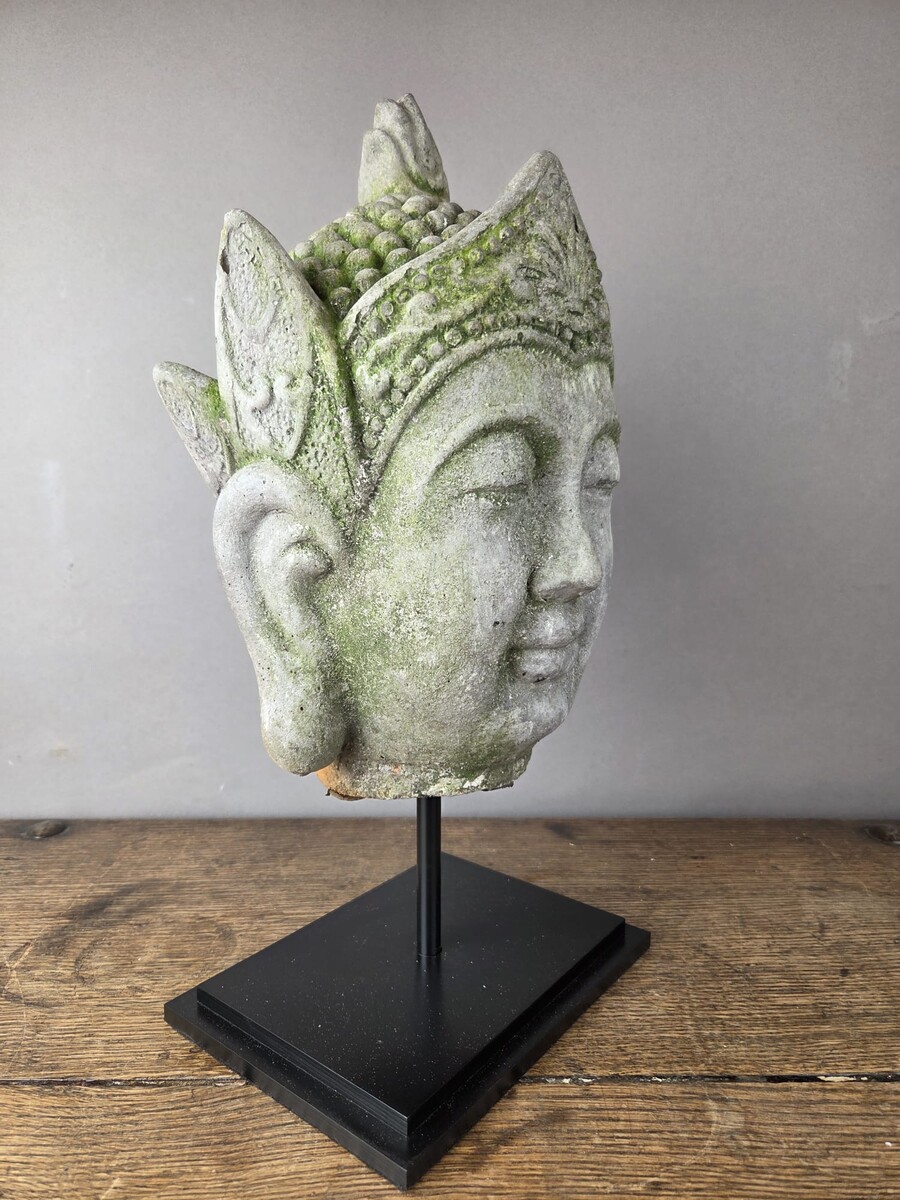 Reconstituted stone Buddha head, mounted on a base, early 20th century 