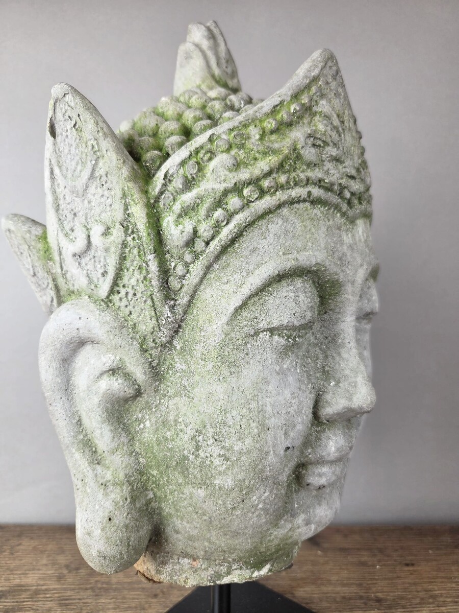 Reconstituted stone Buddha head, mounted on a base, early 20th century 