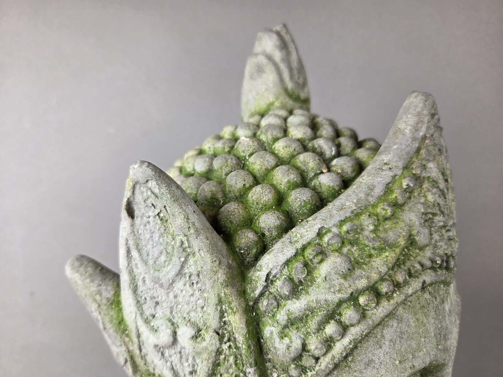 Reconstituted stone Buddha head, mounted on a base, early 20th century 
