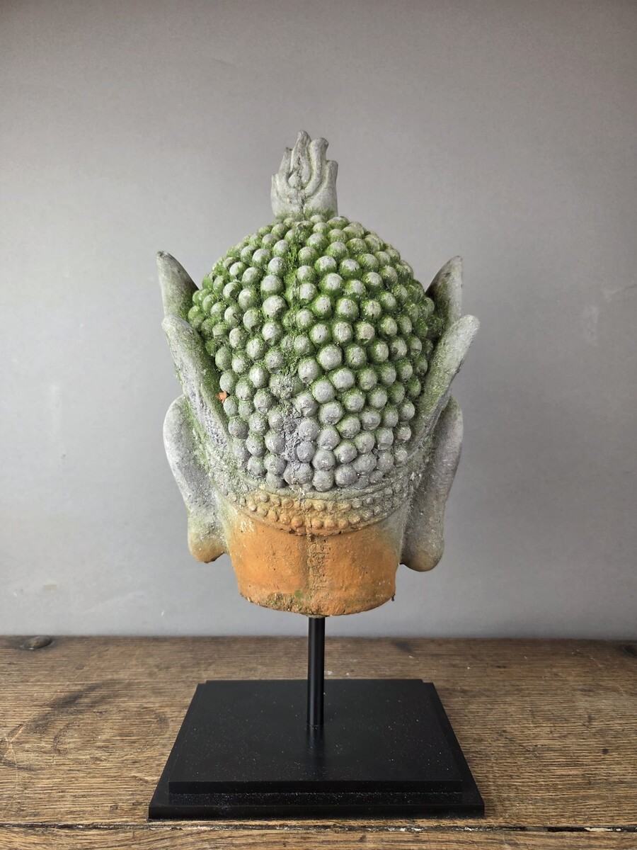 Reconstituted stone Buddha head, mounted on a base, early 20th century 