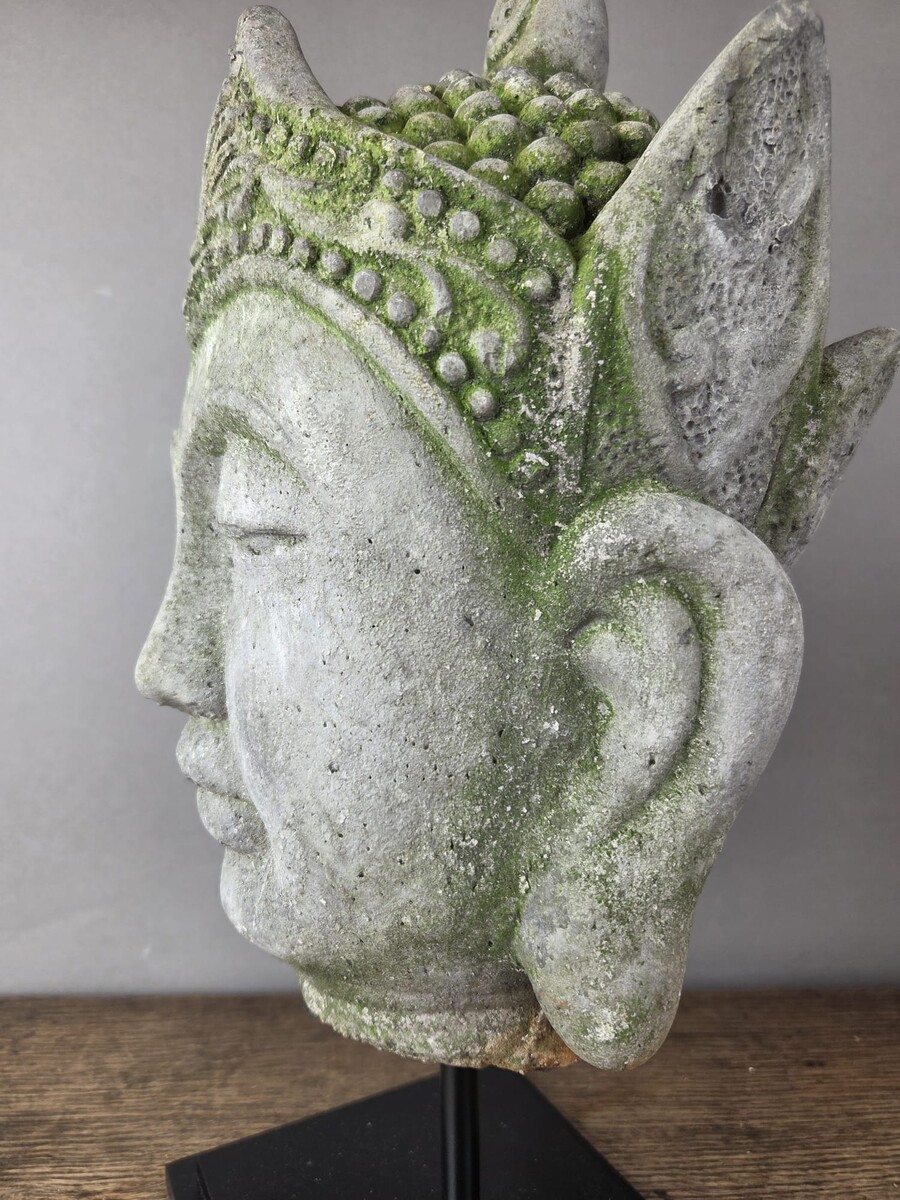 Reconstituted stone Buddha head, mounted on a base, early 20th century 