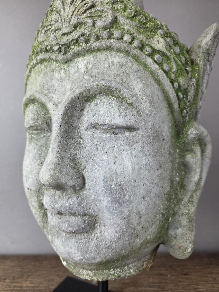 Reconstituted stone Buddha head, mounted on a base, early 20th century 