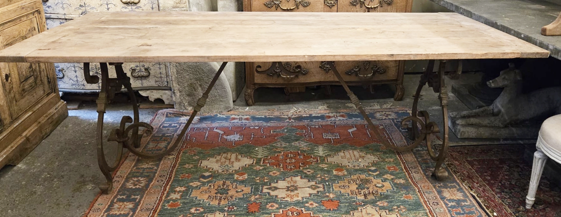 Riveted wrought iron table with teak top