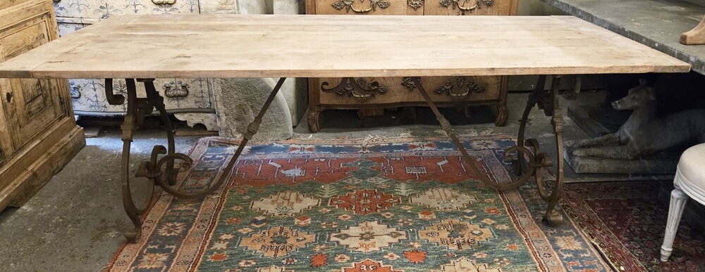 Riveted wrought iron table with teak top