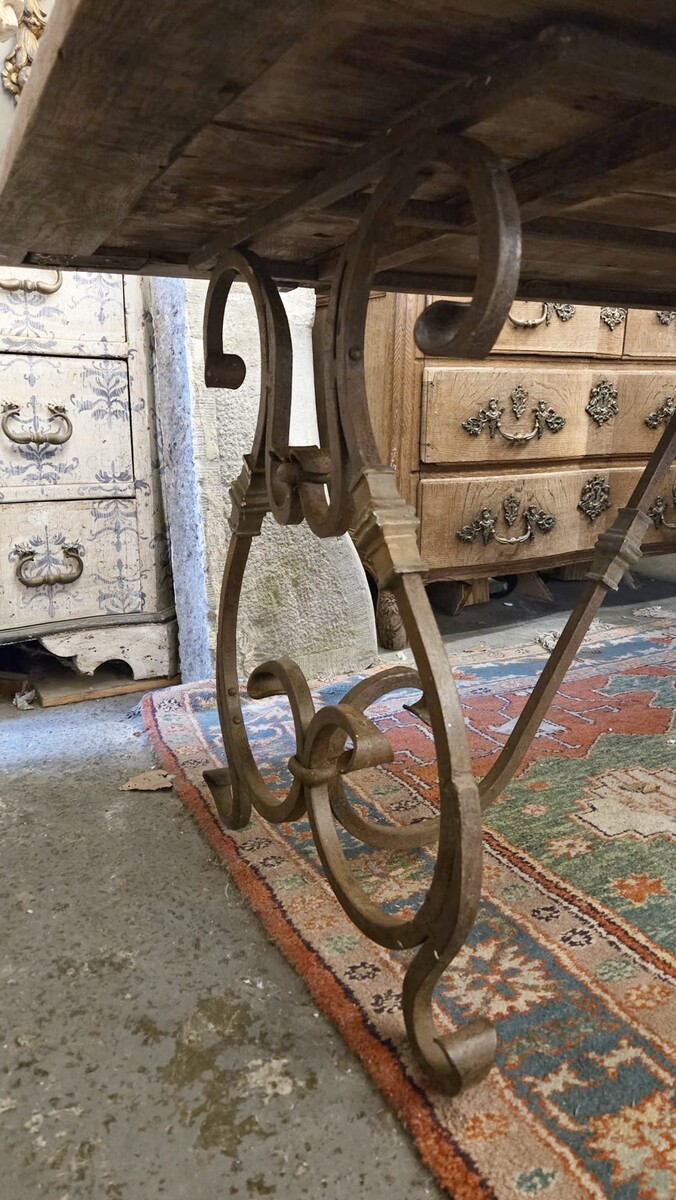 Riveted wrought iron table with teak top