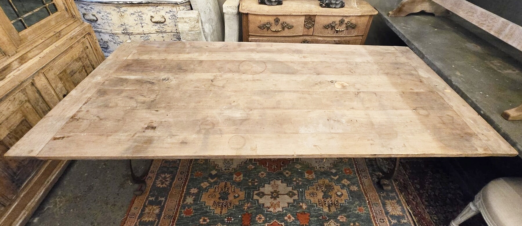 Riveted wrought iron table with teak top