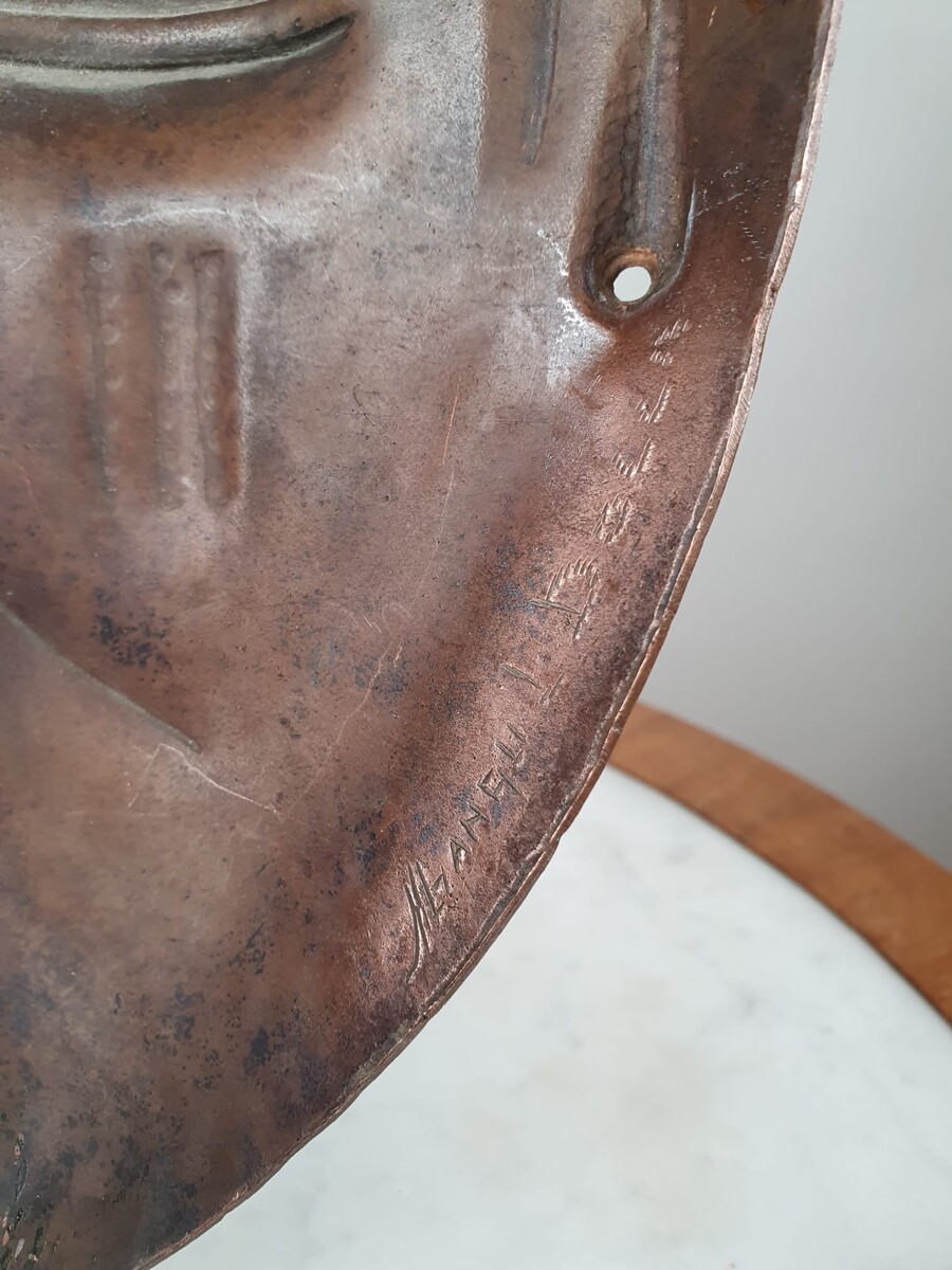 Signed embossed copper mask