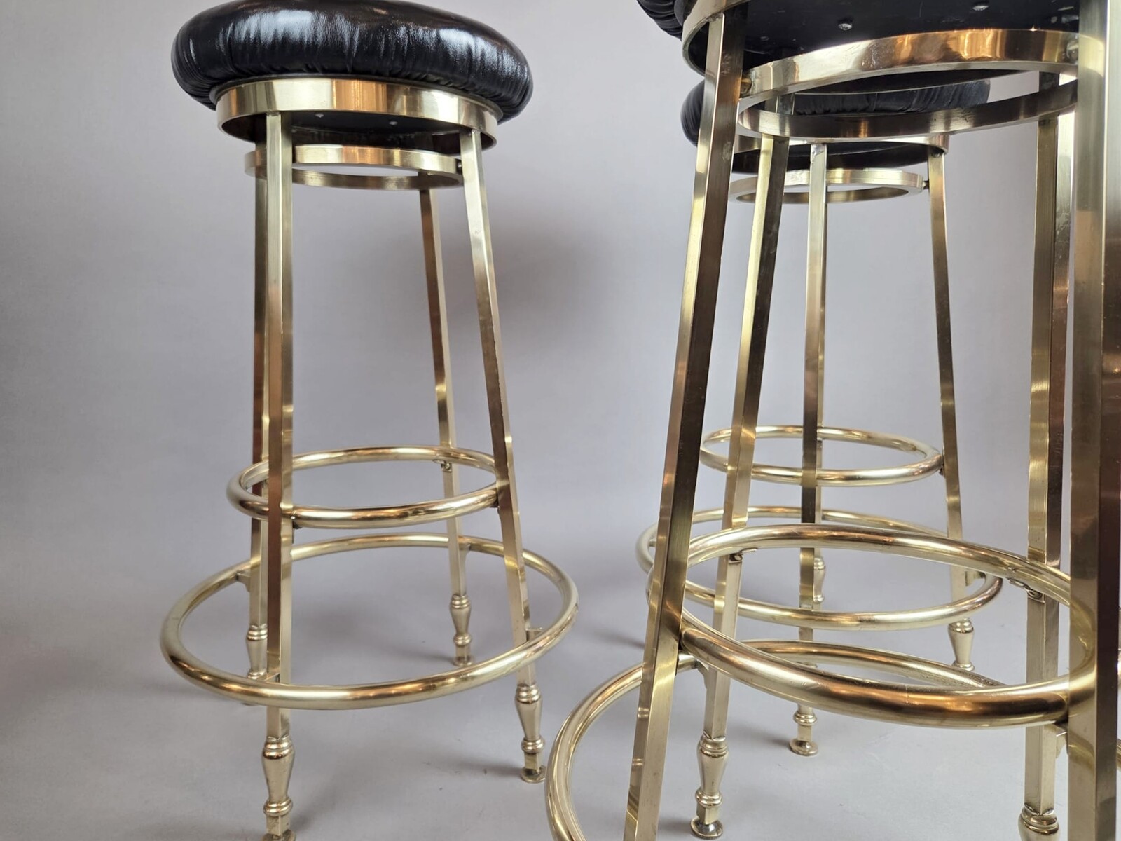 Suite of 3 brass barstools with leather seats, circa 1940