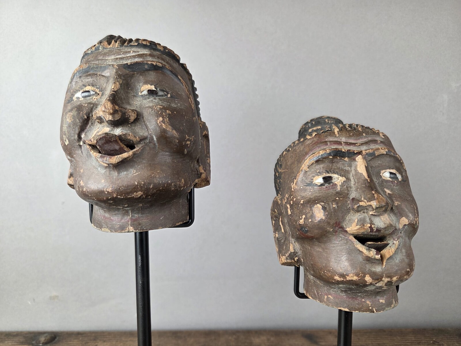Two carved wooden puppet heads on a base, Burma, late 19th century