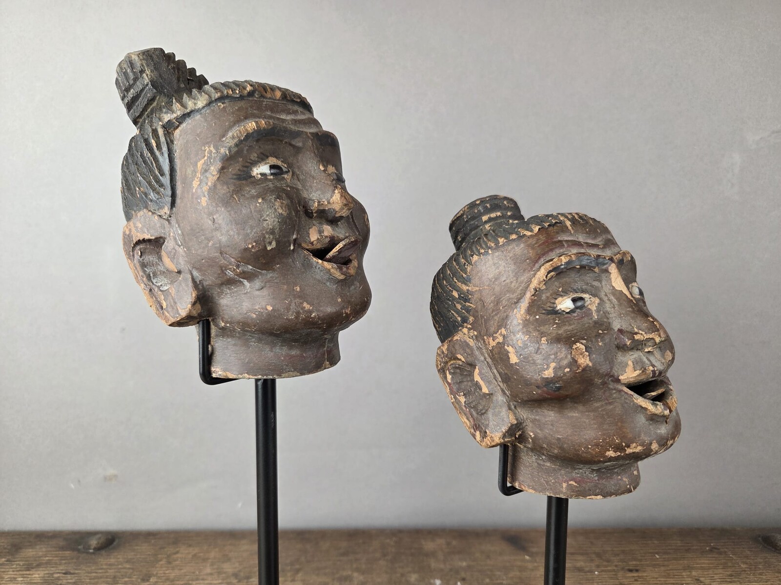 Two carved wooden puppet heads on a base, Burma, late 19th century