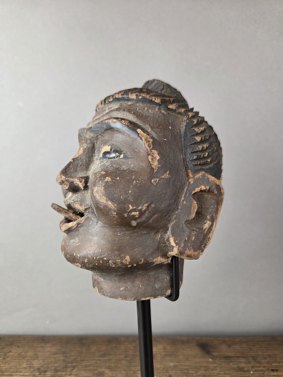 Two carved wooden puppet heads on a base, Burma, late 19th century