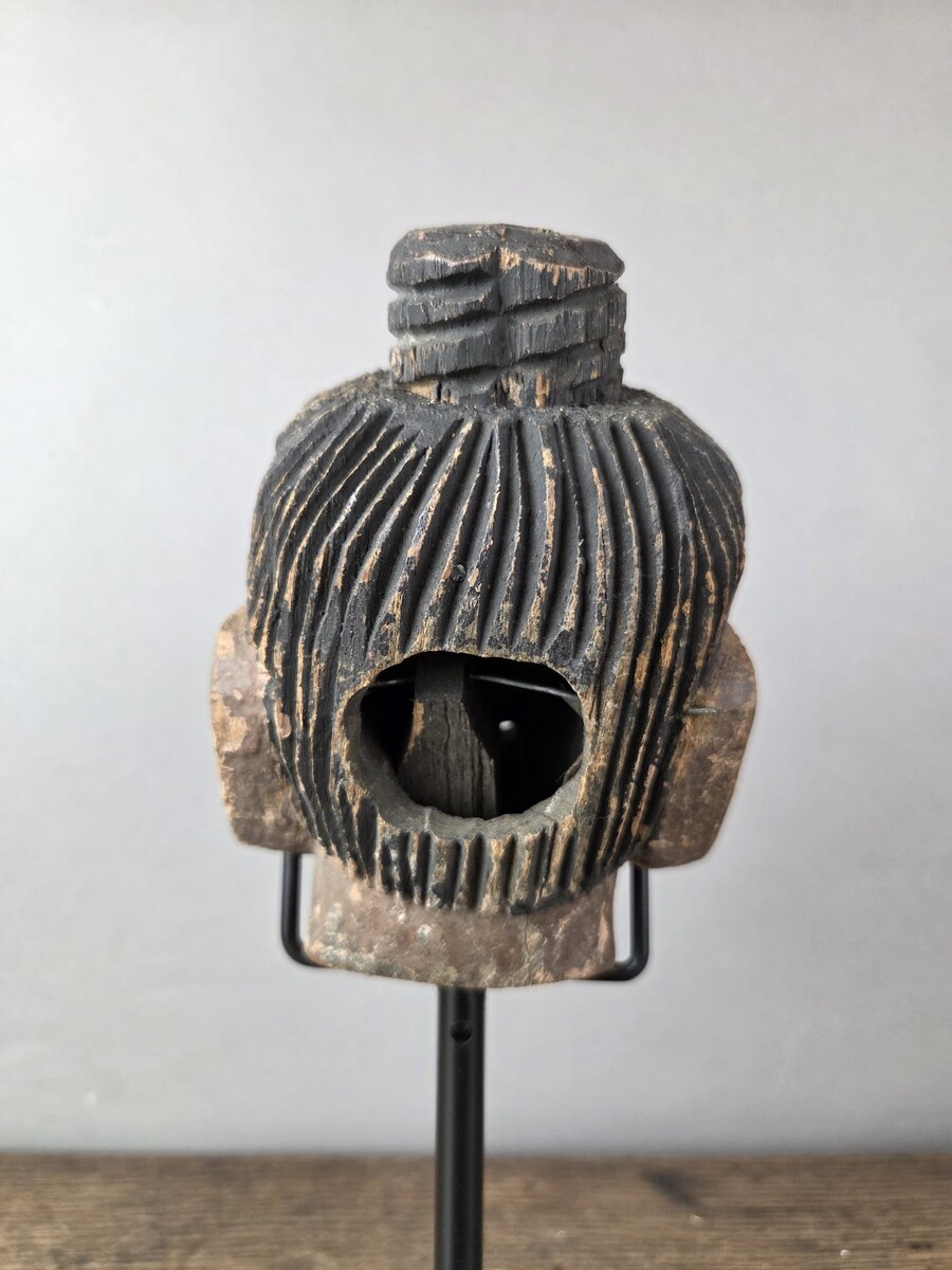 Two carved wooden puppet heads on a base, Burma, late 19th century