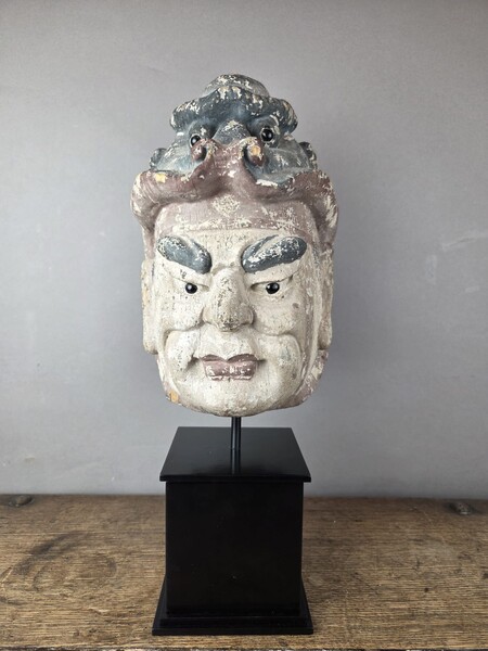 Wooden head on a base, representing a temple guardian, China, late 19th century