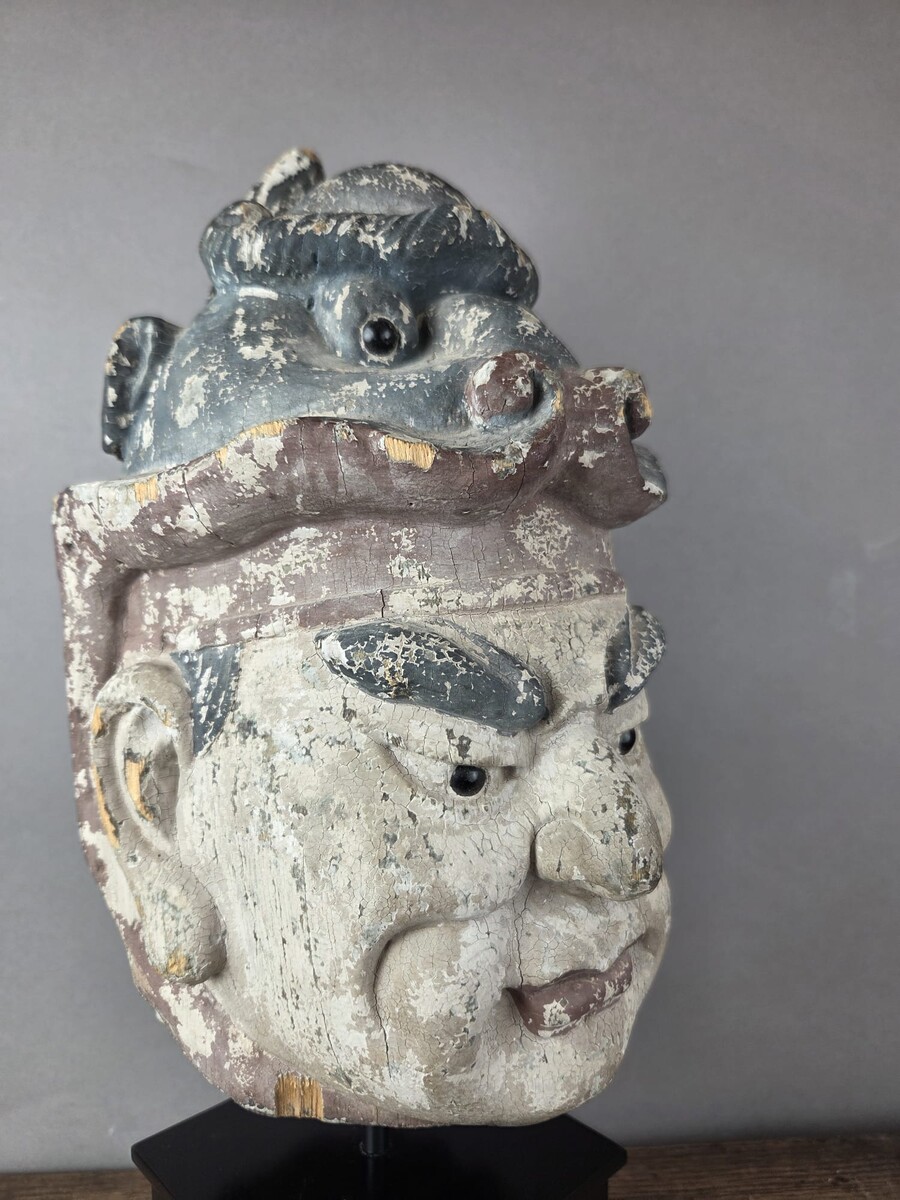 Wooden head on a base, representing a temple guardian, China, late 19th century
