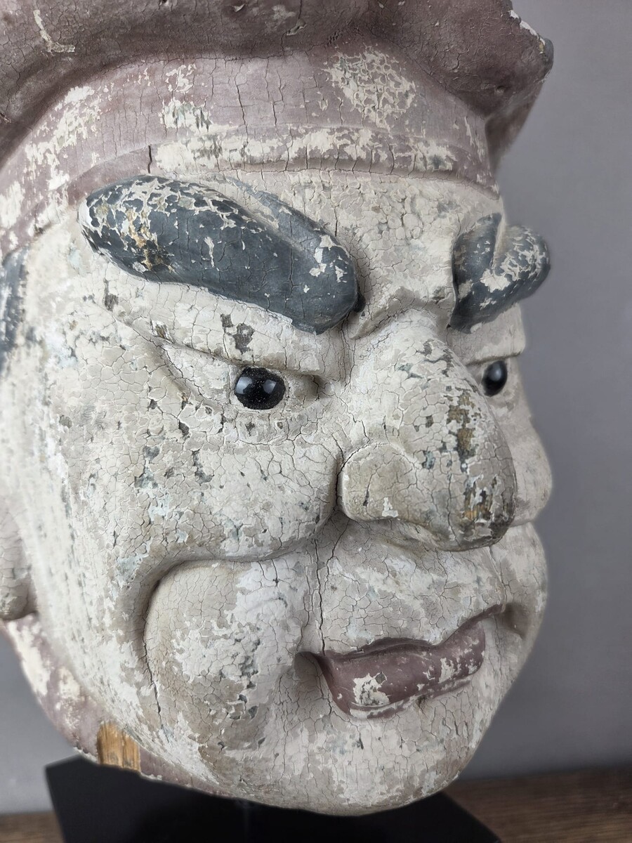 Wooden head on a base, representing a temple guardian, China, late 19th century
