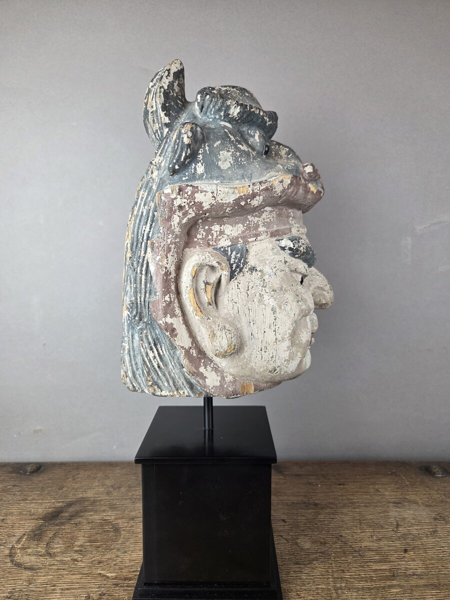 Wooden head on a base, representing a temple guardian, China, late 19th century