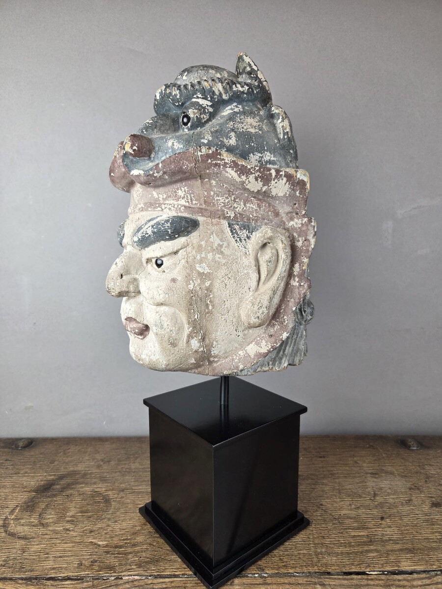 Wooden head on a base, representing a temple guardian, China, late 19th century