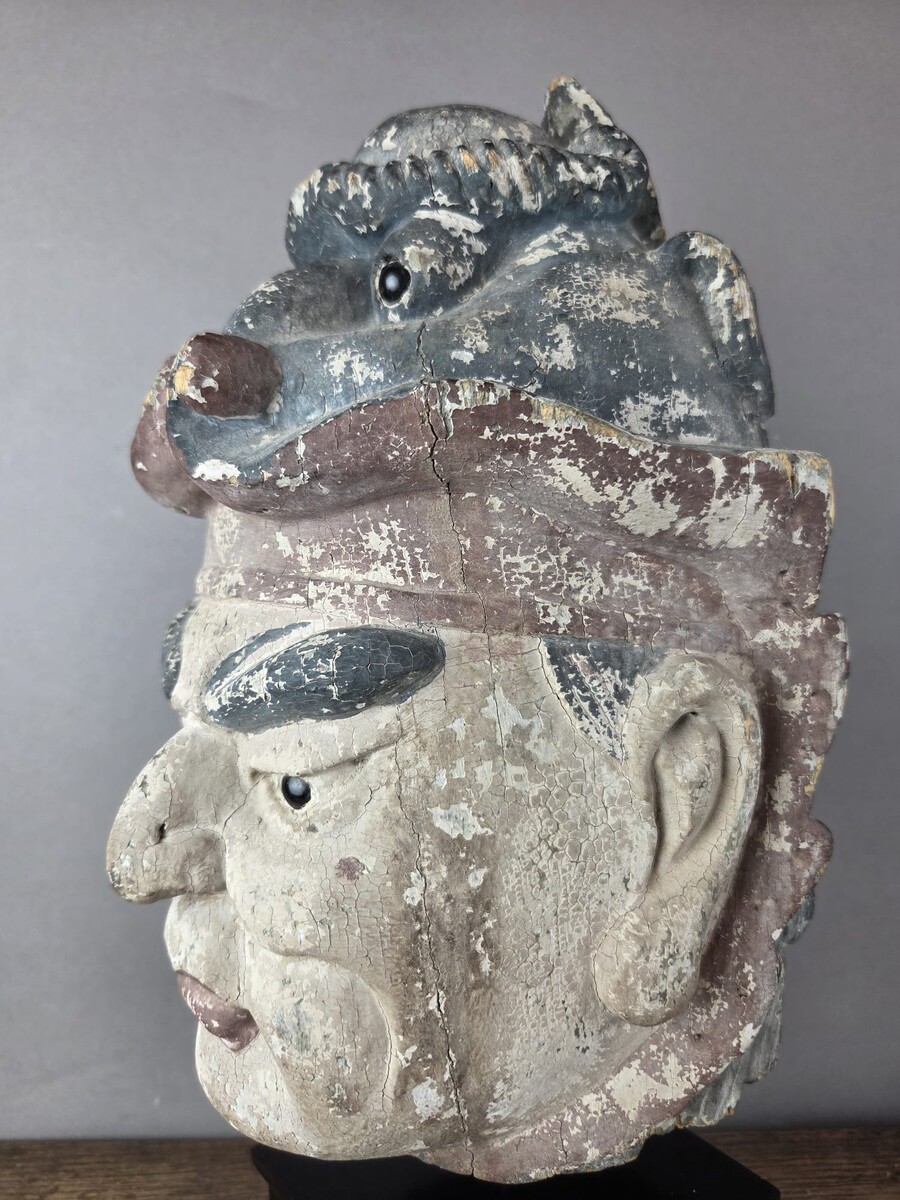 Wooden head on a base, representing a temple guardian, China, late 19th century