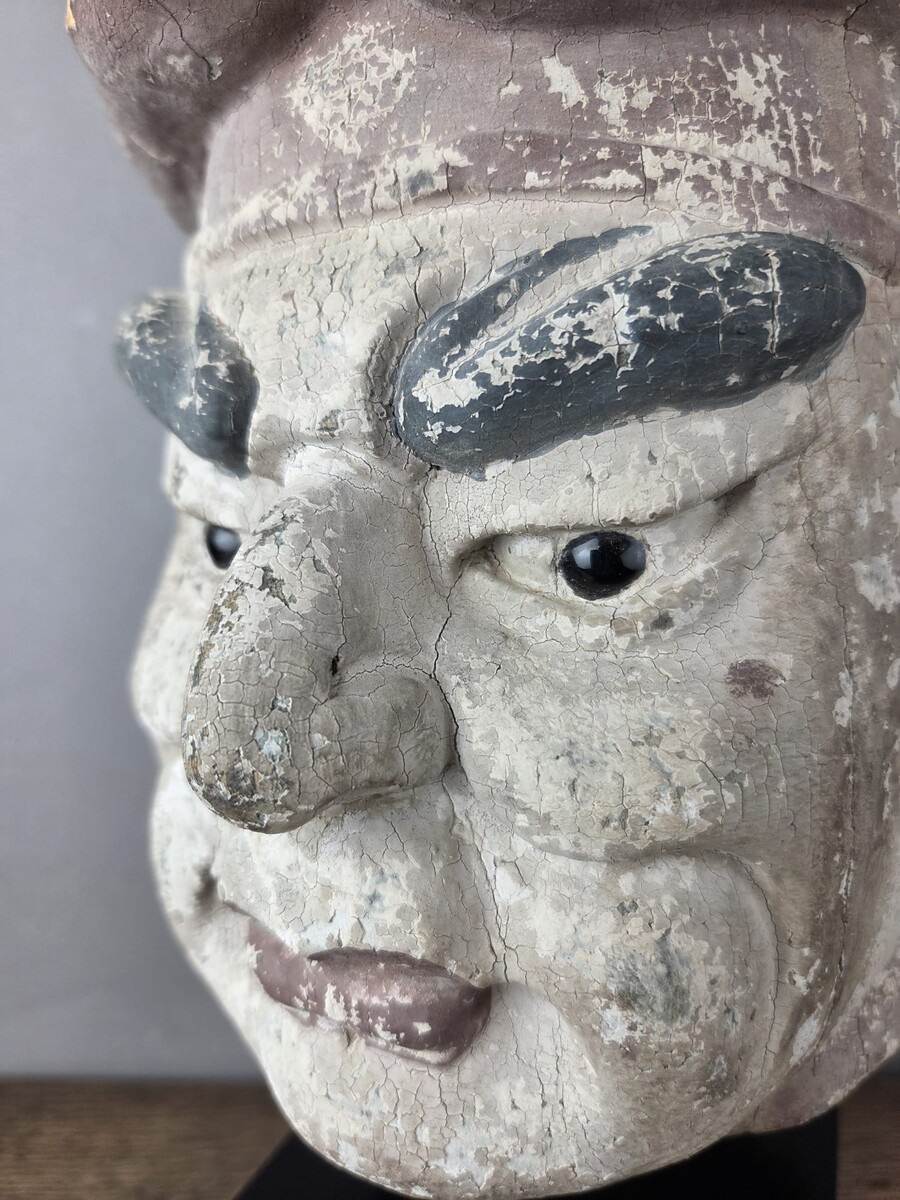 Wooden head on a base, representing a temple guardian, China, late 19th century