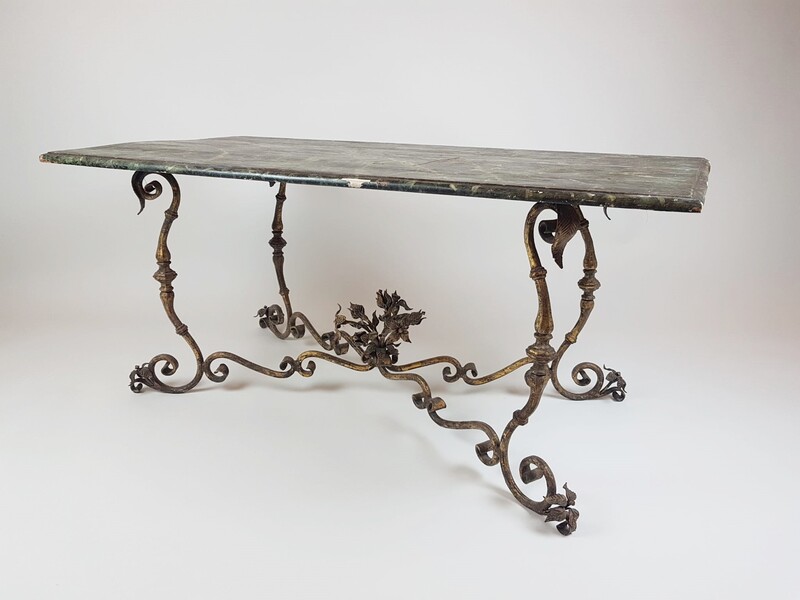 Wrought iron coffee table and trompe l'oeil top simulating marble, circa 1940