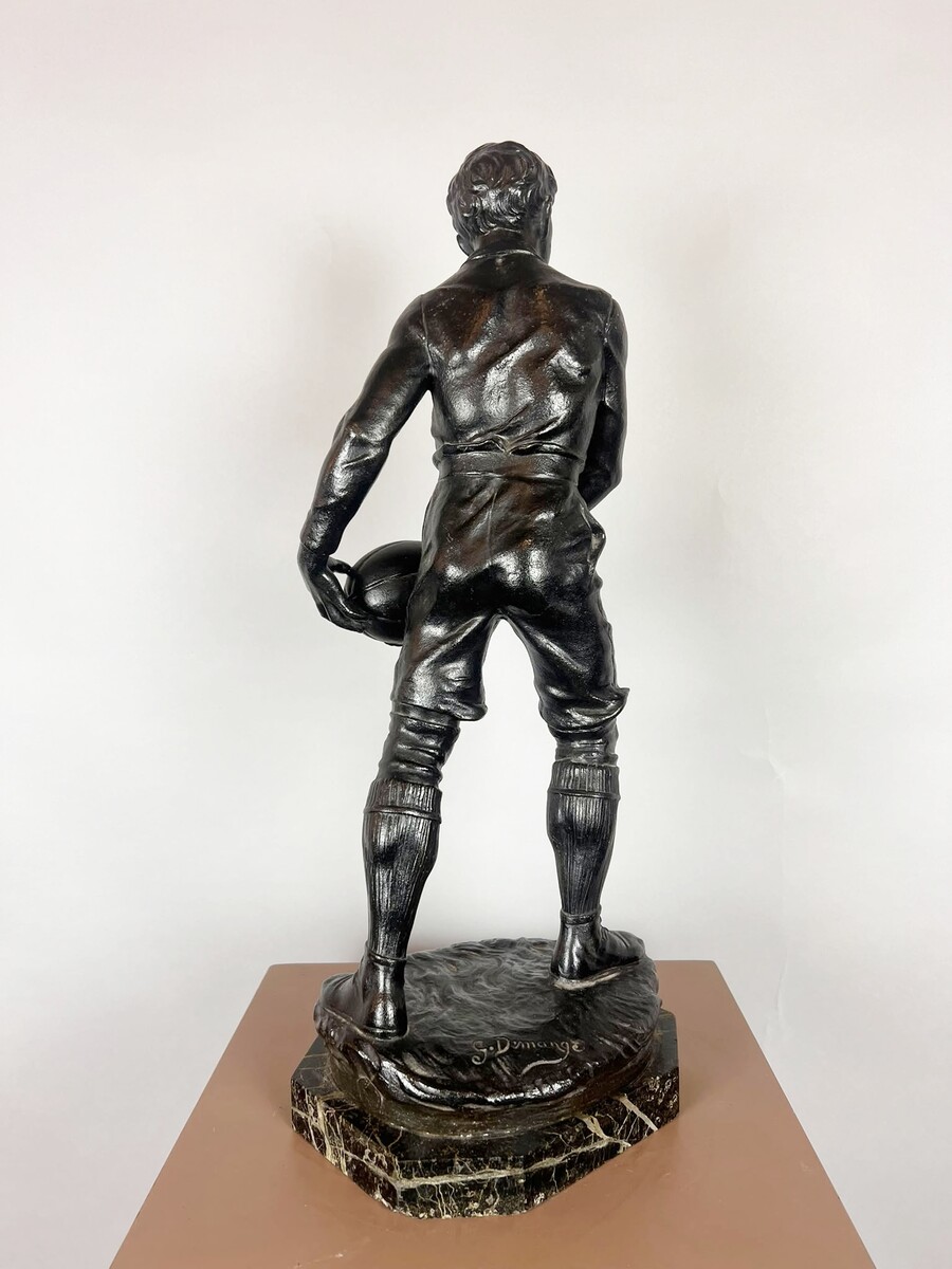 Zamak sculpture depicting The Rugby Player, signed by G. Demange.